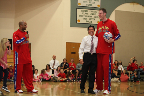 Flight Time Lang (left) and Tiny Sturgess share a laugh with Calvary Christian head of school Vince Downey as students and parents look on. Photo: Margaret Molloy